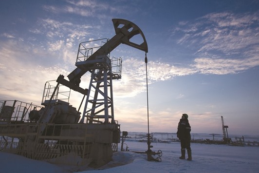 An oil worker inspects a pumping jack during oil drilling operations at an oilfield in Russia. A month after promising co-operation that would re-balance global oil markets, the producer coalition forged by Saudi Arabia and Russia is having difficulty taking its first step.