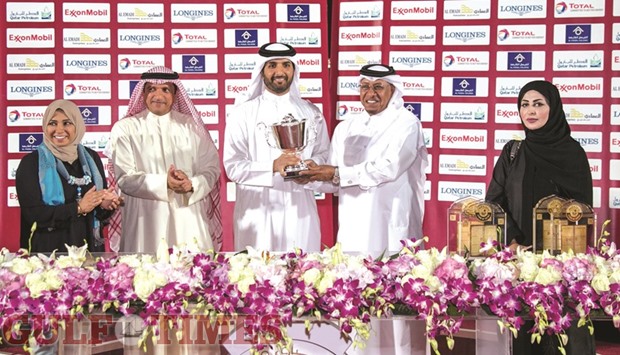 Dr Saif al-Hajri presents the trophy to the winners of the Doha Cup at Qatar Racing and Equestrian Club yesterday. PICTURES: Juhaim