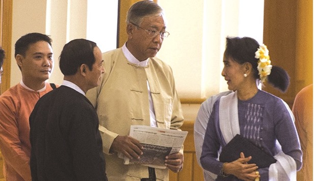 Myanmar lower house parliament speaker Win Myint (second left), Htin Kyaw (second right) and Suu Kyi arrive at the lower house of parliament in Naypyidaw.