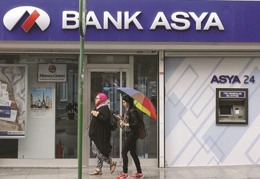 Pedesterians pass a Bank Asya branch in Istanbul. The government seized the assets of the Islamic lender last May, saying its financial structure and management presented a threat to the financial system.