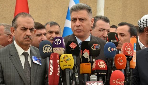 The leader of the Iraqi Turkmen Front, Arshad Salhi (C) and Kirkuk Member of Parliament Hasan Turan (L) attend a press conference in the northern Iraqi city of Kirkuk.