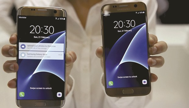 A woman displays Samsung S7 (right) and S7 edge smartphones after their unveiling ceremony at the Mobile World Congress in Barcelona. The worldu2019s largest smartphone vendor faces another difficult year after a 2015 plagued by economic turbulence and volatile exchange rates, chief executive officer Kwon Oh-Hyun said in a letter to shareholders ahead of their annual meeting.