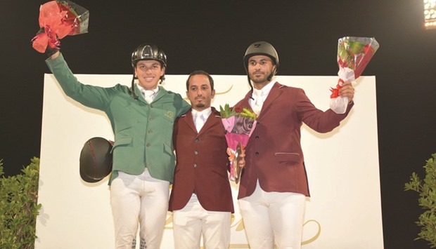 Qataru2019s Faleh Suwead al-Ajami (C), Saudiu2019s Abdullah Alsharbatly, and Qataru2019s Ali Yousef al-Rumaihi (R) celebrate on the podium of CSI4*, the marquee event at the second leg of the QNB Doha Tour, yesterday. PICTURES:  Abdo Garsi