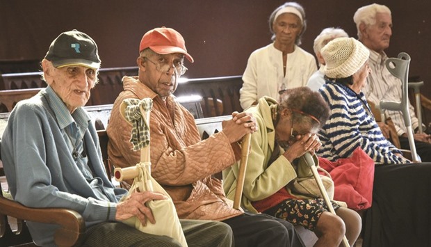 Elderly Cuban people wait for help at La Milagrosa Grandparent House in Havana.