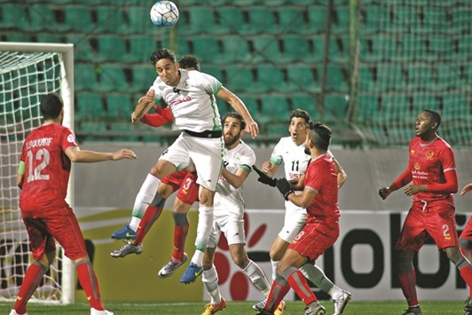 Zobahanu2019s Hadi Mohammadi (C) heads the ball clear during their Asian Champions League match against Qataru2019s Lekhwiya at the Foolad Shahr Stadium in the Iranian city of Isfahan yesterday.