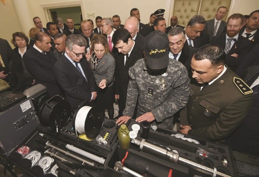 German Interior Minister Thomas de Maiziere and his Tunisian counterpart Hedi Majdoub inspect equipment, offered by Germany, at a national guard barracks in Tunis yesterday.