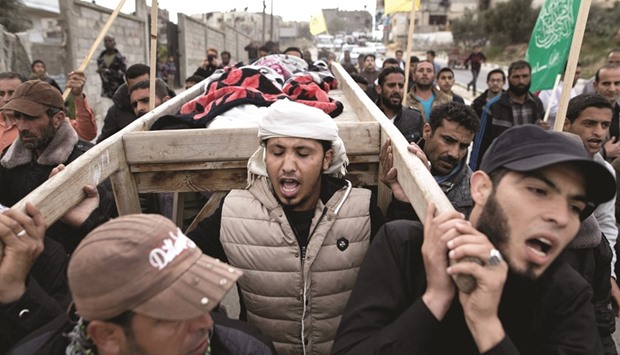 Palestinian mourners carrying the body of Israa Abu Khoussa, 6, during her funeral  in Beit Lahiya in the north of the Gaza strip yesterday.