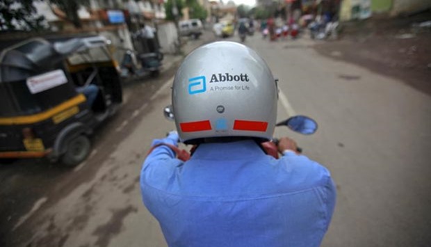 A representative for Abbott rides his motorcycle to a doctor's clinic in Pune in this file picture.