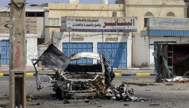 A destroyed car is seen on a street of the al-Mansoura neighbourhood of Yemen's southern port city of Aden. Reuters