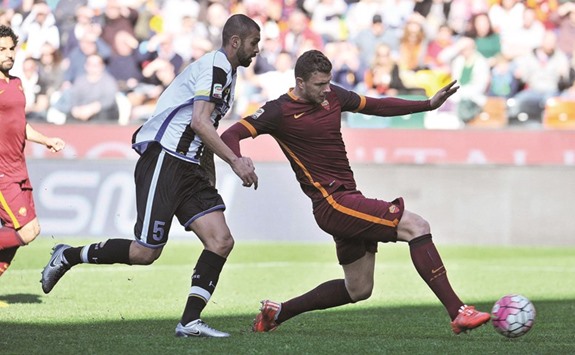 AS Romau2019s Edin Dzeko (right) scores a goal against Udinese during the Italian Serie A match yesterday. (AFP)