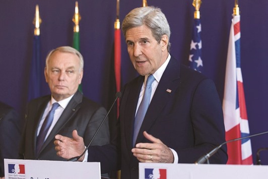US Secretary of State John Kerry (right) speaks as French Foreign Minister Jean-Marc Ayrault looks on following a meeting between the US and its European allies in Paris.