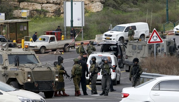 Israeli security forces gather near the scene of attacks