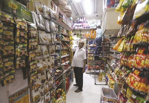 Employees work inside a grocery store at a residential area in Mumbai yesterday. Indiau2019s annual consumer price inflation eased to 5.18% in February from a year ago, helped by a fall in food prices, after edging up for six straight months.
