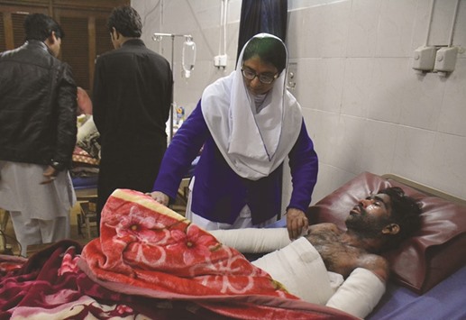 A Pakistani nurse treats a victim injured when a coal mine collapsed at a hospital in Peshawar on March 13. At least five labourers were killed when a coal mine collapsed in northwest Pakistan. More than 30 miners were trapped in the far-flung mountainous Orakzai tribal district after a shaft collapsed amid heavy downpours on March 12.
