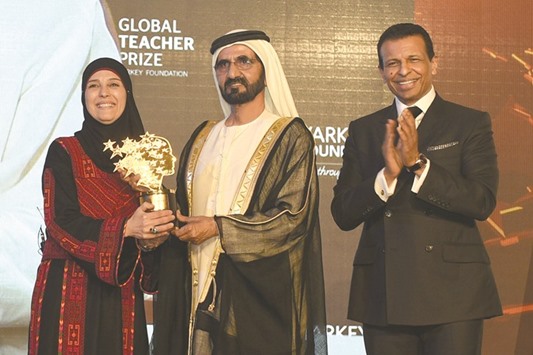 Sheikh Mohamed bin Rashid al-Maktoum, UAE Prime Minister and ruler of Dubai, awarding the $1mn Global Teacher award to Hanan al-Hroub, a Palestinian teacher from the West Bank for her innovative approach of using play to counter violent behaviour, as Sunny Varkey, the chairman of the Dubai-based Varkey Foundation that set up the award two years ago, claps.