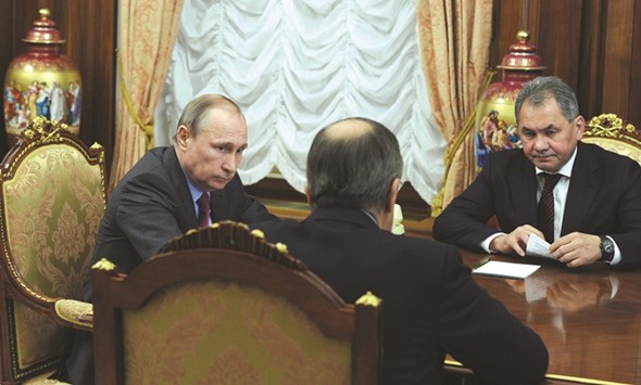 Russian President Vladimir Putin meets with Defence Minister Sergei Shoigu (right) and Foreign Minister Sergei Lavrov (centre) at the Kremlin in Moscow yesterday. Russian President Vladimir Putin on March 14 ordered the defence ministry to begin the withdrawal of Russian forces from Syria today.