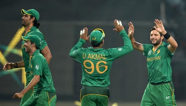 Pakistan's captain Shahid Afridi (right) celebrates with teammates after the dismissal of Bangladesh's Sabbir Rahman during the World T20 match at the Eden Gardens in Kolkata.
