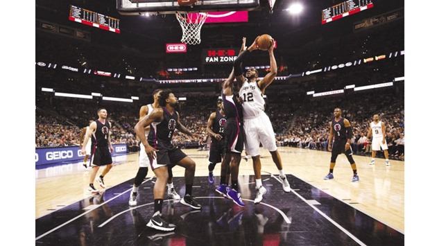 San Antonio Spurs power forward LaMarcus Aldridge (right) shoots the ball during the first half of the NBA game against San Antonio Spurs on Tuesday. (USA TODAY Sports)
