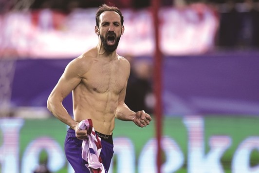 Atletico Madridu2019s defender Juanfran celebrates after kicking the winning penalty during the UEFA Champions League last sixteen second leg match against PSV Eindhoven at the Vicente Calderon stadium in Madrid.  (AFP)