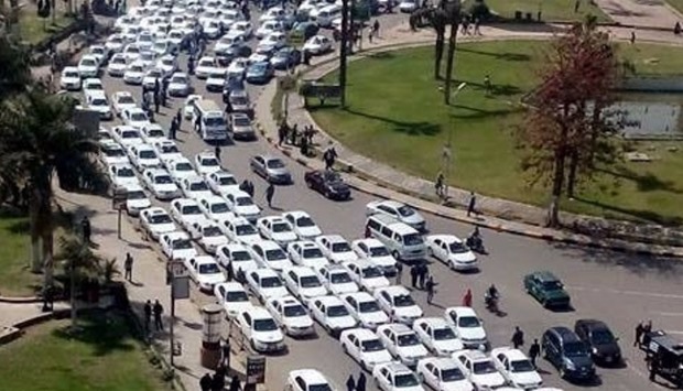 Taxis protesting against Uber and Careem services park on a busy road in central Cairo, causing traffic jam, on March 11
