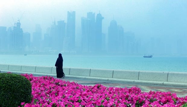 Residents take a stroll along the Corniche as a fog envelops the skyline on Wednesday morning. PICTURE: Jayan Orma