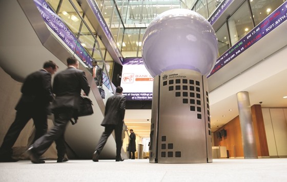 Visitors pass a sign inside the London Stock Exchange. The FTSE 100 closed up 0.6% to 6,175.49 points yesterday.