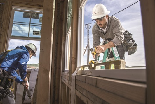 Contractors install a window on a home under construction at Gale Ranch development in San Ramon, California. The Commerce Department said housing starts increased 5.2% to a seasonally adjusted annual pace of 1.18mn units last month, the highest level in five months.