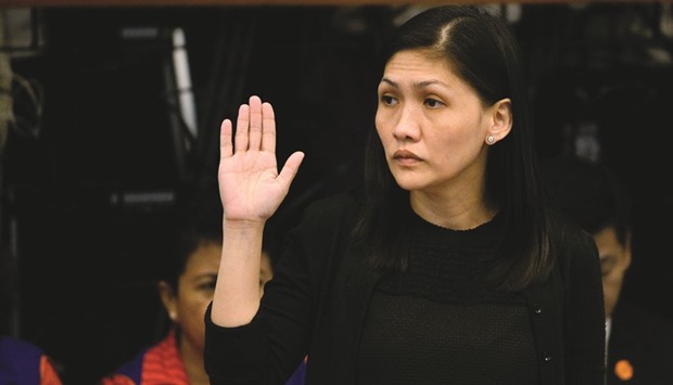 Rizal Commercial Banking Corp (RCBC) branch manager Maia Santos-Deguito takes an oath during a senate hearing in Manila.