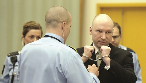 Breivik has his handcuffs removed yesterday inside the courtroom in Skien prison.