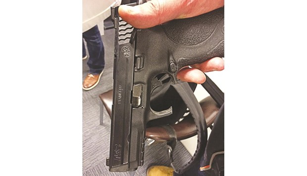 A handout photo released yesterday during a press conference by the Belgian federal police shows the firearm of one of the police officers, which was still in the hip holster when it was struck by a bullet during the gun fight on Tuesday.