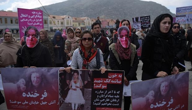 Afghan activists march before artists performed a play depicting the 2015 lynching of Afghan woman Farkhunda, in Kabul on Thursday.