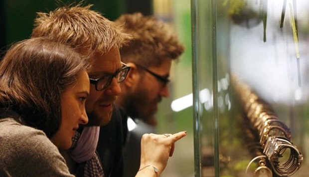 Visitors watch the display of Rolex at the Baselworld watch and jewellery fair in Basel on Thursday.