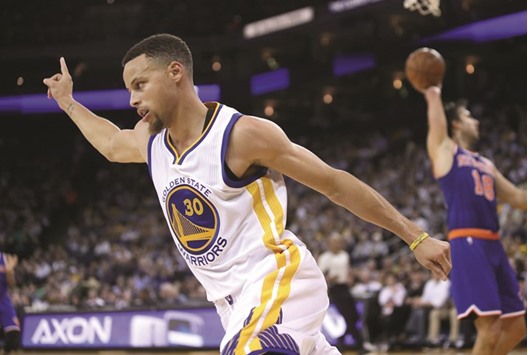 Stephen Curry of the Golden State Warriors reacts after making a basket against the New York Knicks at ORACLE Arena in Oakland, California. (AFP)