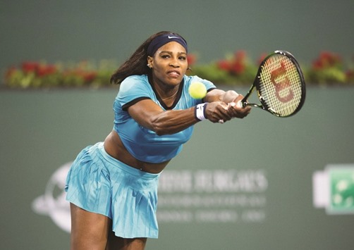 Serena Williams of USA returns a shot to Simona Halep of Romania during the womenu2019s quarterfinals at the BNP Paribas Open at the Indian Wells Tennis Garden in Indian Wells, California. (AFP)