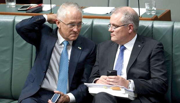Australian Prime Minister Malcolm Turnbull (left) speaks with Treasurer Scott Morrison during question time in the House of Representatives at Parliament House in Canberra.