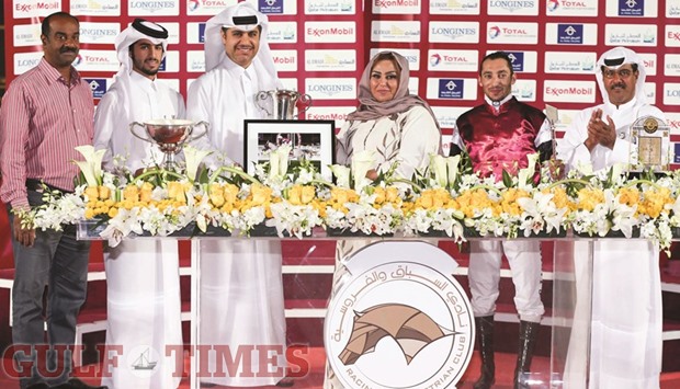 Gulf Disability Societyu2019s Alyazi al-Kuwari and Qatar Racing and Equestrian Clubu2019s Racing manager Abdullah Rashid al-Kubaisi with the winners of the Purebred Arabians Sprinter Championship (Gr3PA) at the QREC yesterday. PICTURES: Juhaim