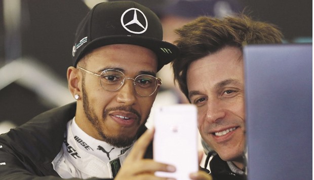 Mercedes driver Lewis Hamilton (left) takes a selfie with team boss Toto Wolff in the team garage during the second practice session at the Australian Grand Prix in Melbourne yesterday. (Reuters)