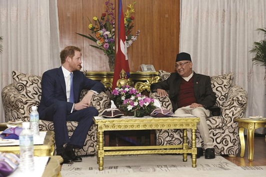 Britainu2019s Prince Harry, left, meeting with Nepalu2019s Prime Minister Khadga Prasad Sharma Oli, at his office at Singha Durbar in Kathmandu yesterday.