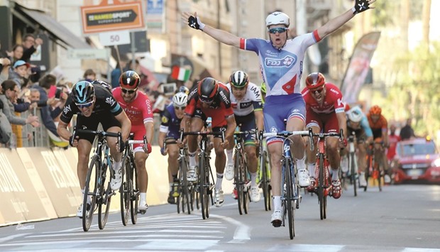 French rider Arnaud Demare celebrates as he crosses the finish line to win the Milan - San Remo cycling race in San Remo yesterday.
