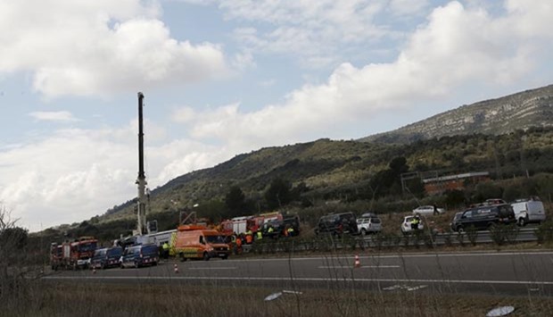 Emergency and rescue teams work at the scene of a traffic accident in Freginals, Spain on Sunday.