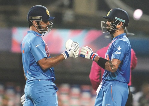 Mahendra Singh Dhoni (left) and Virat Kohli celebrate after their win over Pakistan at the World T20 in Kolkata. (AFP)