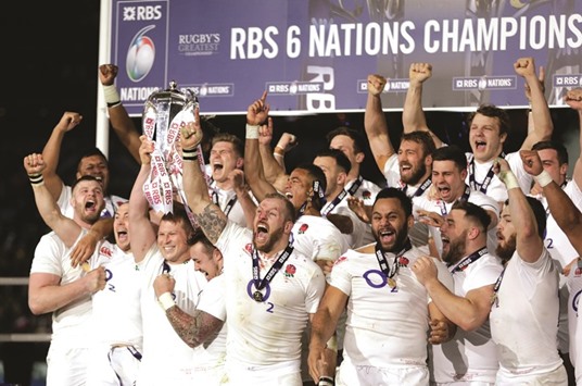 England players celebrate with the Six Nations Championship trophy yesterday. (AFP)