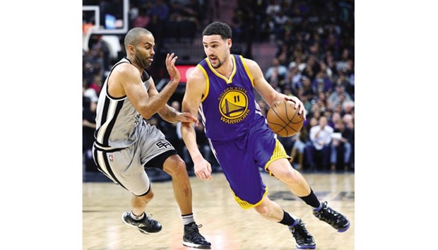 Golden State Warriors guard Klay Thompson (11) drives against San Antonio Spurs guard Tony Parker (9) during their NBA game on Saturday. (Erich Schlegel-USA TODAY Sports)
