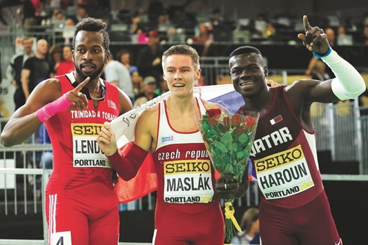 World Indoors 400m silver medallist Abdalelah Haroun of Qatar (right) celebrates on the podium with Pavel Maslak of the Czech Republic, who won the gold, and bronze medallist Deon Lendore of Trinidad and Tobago, on Day 3 of the IAAF World Indoor Athletics Championships in Portland, Oregon. (Reuters)