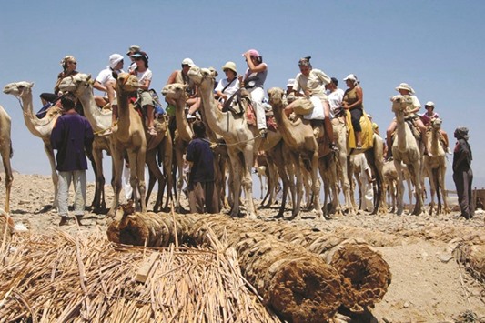 Tourists on the Sinai seacoast while riding camels (file). The funds will be used u201cfor development projectsu201d in agriculture and to build 26 residential complexes that would also include hospitals and schools.