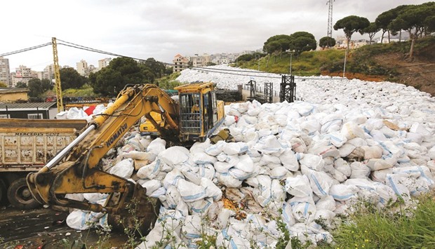 Trucks began moving stacked rubbish outside Beirut under a plan adopted by the Lebanese government to put an end to the waste crisis that has been going on for eight months.