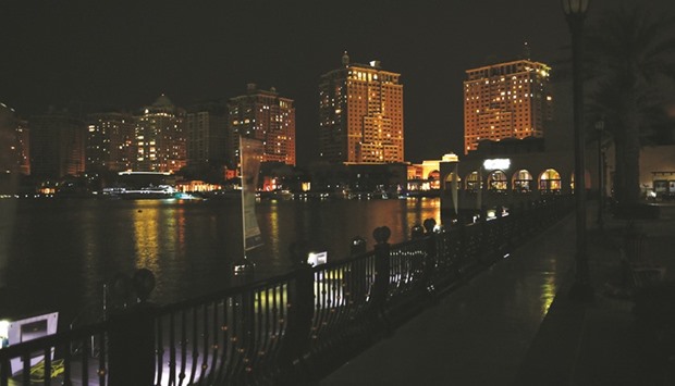The Pearl-Qatar before the lights were switched off and during Earth Hour.
