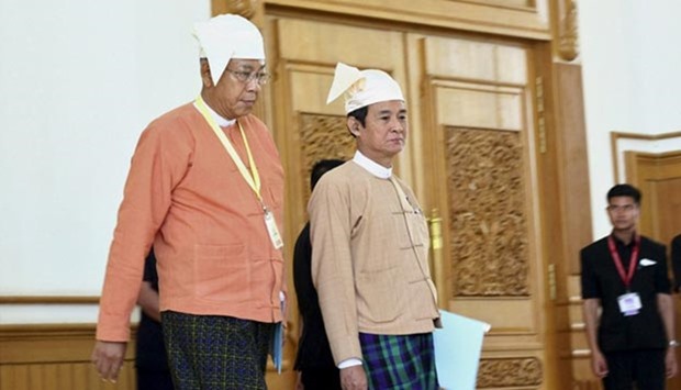Myanmar's newly-elected President Htin Kyaw (left) and Win Myint, Speaker of Lower House of Parliament, arrive at the Union Parliament in Naypyitaw on Monday.