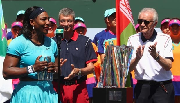Serena Williams talks to the crowd alongside Indian Wells CEO Raymond Moore after her loss to Victoria Azarenka in the final at Indian Wells tournament.