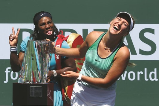 Victoria Azarenka of Belarus laughs with the winners trophy as Serena Williams of USA pulls a face after the final of the BNP Paribas Open in Indian Wells, California.